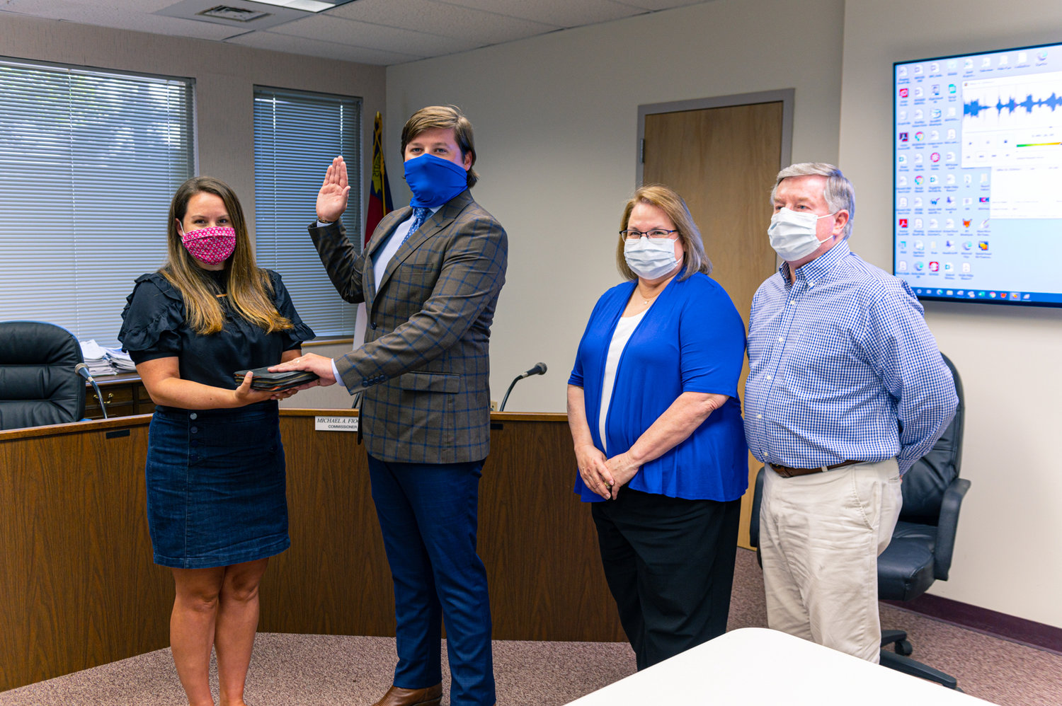 Chris Kennedy (second to left) is sworn in as his wife (left), Emily held a family Bible. He was joined by his parents Debbie and Dale Kennedy (right) of Asheboro.